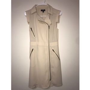 A bebe cream tan dress with zippers.